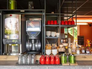 a kitchen with a coffee maker and a counter with aperature at ibis budget Lyon Centre Confluence in Lyon
