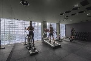 a group of people exercising on tread machines in a gym at Episode Tbilisi in Tbilisi City