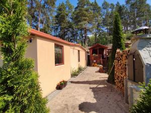 a house with a pathway leading to a yard at Betlejem Nad Jeziorem in Gostyczyn +6 photos