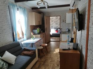 a living room with a couch and a bedroom at Betlejem Nad Jeziorem in Gostyczyn