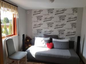 a bedroom with a bed and a wall with writing on it at Betlejem Nad Jeziorem in Gostyczyn