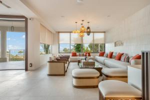 a living room with a couch and chairs at Kouros Palace Active Lifestyle Hotel in Mastihari