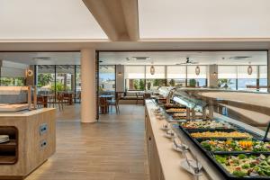 a buffet line with many different types of food at Kouros Palace Active Lifestyle Hotel in Mastihari