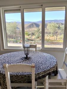 a dining room table with a view of the mountains at Finca Indalopez in Tabernas