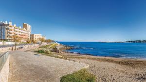 a view of a beach with buildings and the ocean at Apartamento SoliMar by VACAY L'Escala in L'Escala