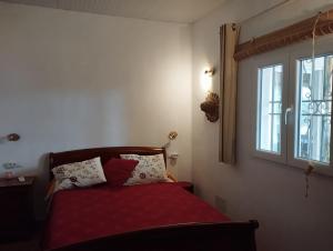 a bedroom with a bed with red sheets and a window at Finca Indalopez in Tabernas +33 photos