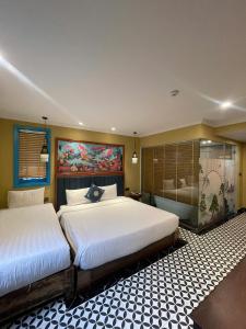 a hotel room with two beds and a shower at SAPA DEBOUTIQUE Hotel in Sapa +52 photos