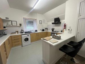 a kitchen with a counter and a sink and a dishwasher at Dun-Niall Apartment in Oban