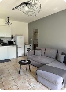 a living room with a couch and a table at Mini villa in Corte