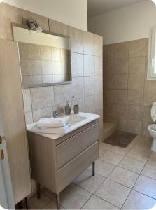 a bathroom with a sink and a toilet at Mini villa in Corte
