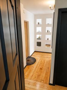 a hallway with a cat laying on a hard wood floor at Romance Apartments in Panevėžys