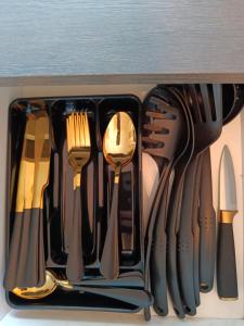 a drawer full of utensils in a drawer at Romance Apartments in Panevėžys