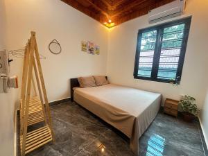 a bedroom with a bed and a ladder in it at NinhBinh Central Homestay l Green Path in Xuân Sơn