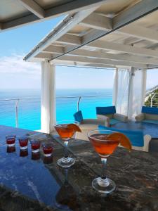a table with two martini glasses on top of it at Okeanos Vine Luxury Villa in Athani