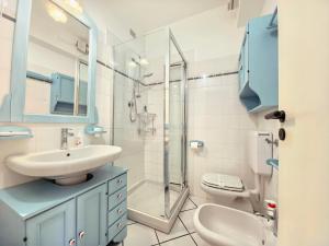 a bathroom with a sink and a shower and a toilet at Casa Ghibli in Loano +20 photos