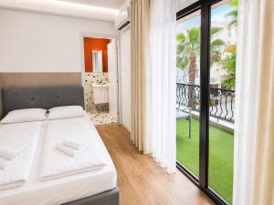 a bedroom with a bed and a balcony at Modern Studio 8 Balcony Kitchenette Bathroom in Limassol