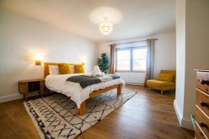 a bedroom with a bed and a couch and a window at High Street Retreat in Whitstable