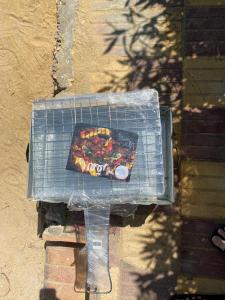 a grill with a pizza on top of it at ارضي جنينه قريه التجاريين in Dawwār ‘Abd Allāh