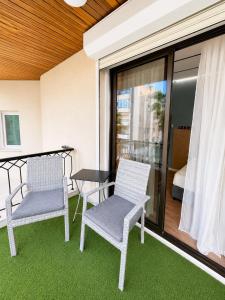 two chairs and a table on a balcony at Modern Studio 8 Balcony Kitchenette Bathroom in Limassol +7 photos