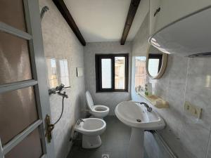 a small bathroom with a sink and a toilet at Villa Emma Durrës in Durrës +30 photos