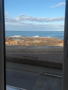 a view of the ocean from a train window at The Esplanade Apartment in Peterhead