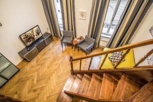 プラハにあるColonial Ruterra 2BDR Apartmentの階段と椅子付きのリビングルームのオーバーヘッドビュー