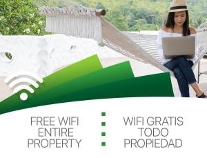a woman sitting in a hammock with a laptop at CARIBBEAN DREAMS Apartment & Villas - OCEAN VIEW - POOL - BBQ in Punta Cana