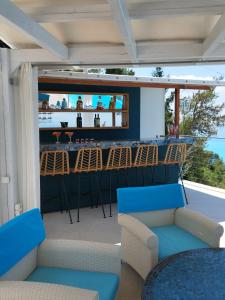a bar on the balcony of a house at Okeanos Vine Luxury Villa in Athani