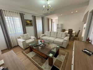 a living room with a couch and a table at Vila Nela in Shkodër