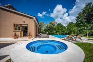 a swimming pool in the backyard of a house at Villa Ferlini in Central Istria with private 10000 m2 garden, wellness & family activities on plot in Svetvinčenat