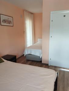 a bedroom with two beds and a sliding door at Mavi Ev in Köyceğiz