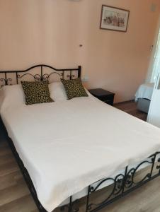 a large bed with white sheets and pillows at Mavi Ev in Köyceğiz