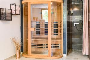a wooden cabinet in a bathroom with a shower at Villa Ferlini in Central Istria with private 10000 m2 garden, wellness & family activities on plot in Svetvinčenat