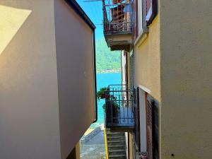 an alley with stairs and balconies on a building at White Suite Lakeside in Colonno