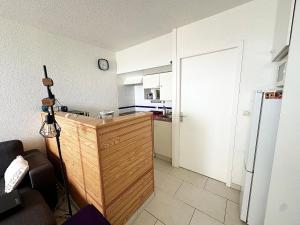 a kitchen with a wooden counter and a refrigerator at Le Grand Large - T2 vue océan in Mimizan-Plage +4 photos