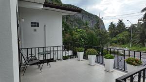 a balcony with potted plants and a table and chairs at Sanfhan Resort-SHA Plus in Khao Chai Son