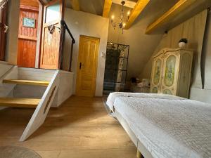 a bedroom with a bed and a staircase in it at Saschiz 130/Lodging and Glamping in Saschiz +45 photos
