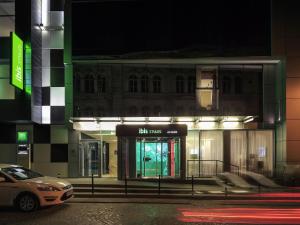 a car parked in front of a building at night at Ibis Styles Lviv Center in Lviv