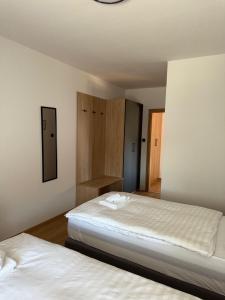 a bedroom with two beds and a shelf and two bedsvisor at Gaja in Križpolje