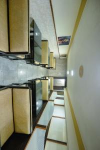 a kitchen with a row of counters and cabinets at Hotel Durga International in Udupi