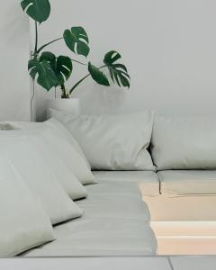 a white couch with a potted plant on it at TSUKIMI HOTEL in Kyoto +24 photos