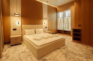 a bedroom with a large bed in a room at EUROPA Hotel in Semey