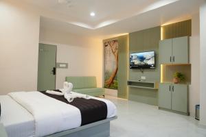 a bedroom with a bed with an animal on top of it at Hotel The Avanta- Naroda in Naroda +32 photos