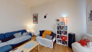a living room with a blue couch and a table at Amimoni Apartment in Nafplio