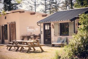 a picnic table in front of a house at Cabane Cheverny in Le Controis En Sologne
