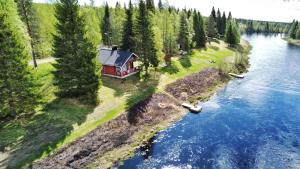 an aerial view of a house next to a river at Lapland Aurora Riverside in Raiskio