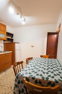 a kitchen with a table with a green and white table cloth at B&BCasamí in Boscoreale +15 photos