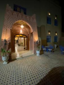 a lobby with a tiled floor in a building at Riad Dar Fatima in Merzouga