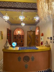 a kitchen with a island in a room at Riad Dar Fatima in Merzouga