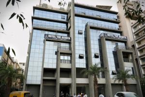 a building in a city with people in front of it at Hotel The Avanta- Naroda in Naroda
